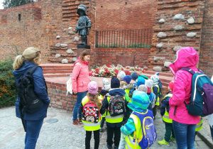 Dzieci oglądające pomnik Małego Powstańca